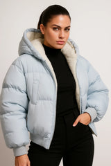 Light blue puffer jacket with hood and faux shearling lining, cozy winter outerwear for women.